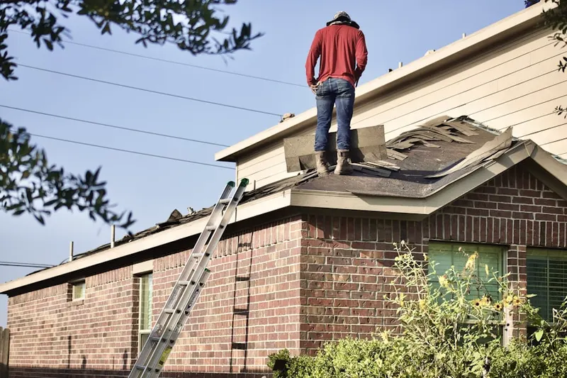 Professional roofer working on a residential roof in Stoneville
